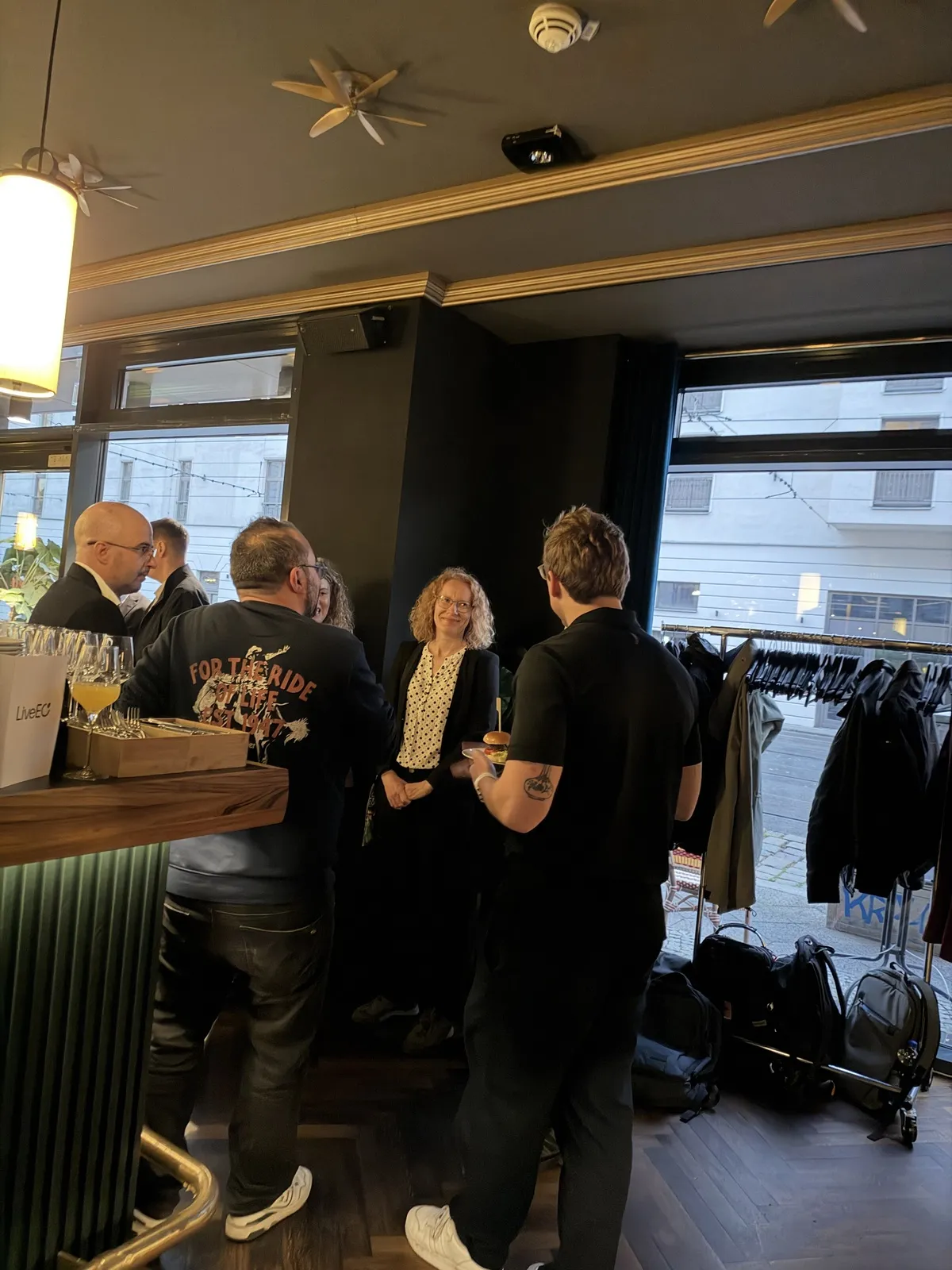 Participants talking at the bar on the evening before the forum