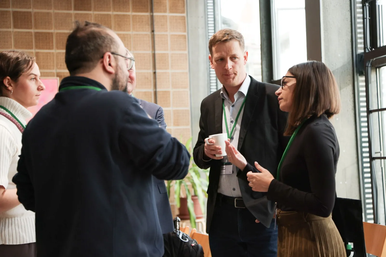 Participants in conversation over coffee at the 2026 forum