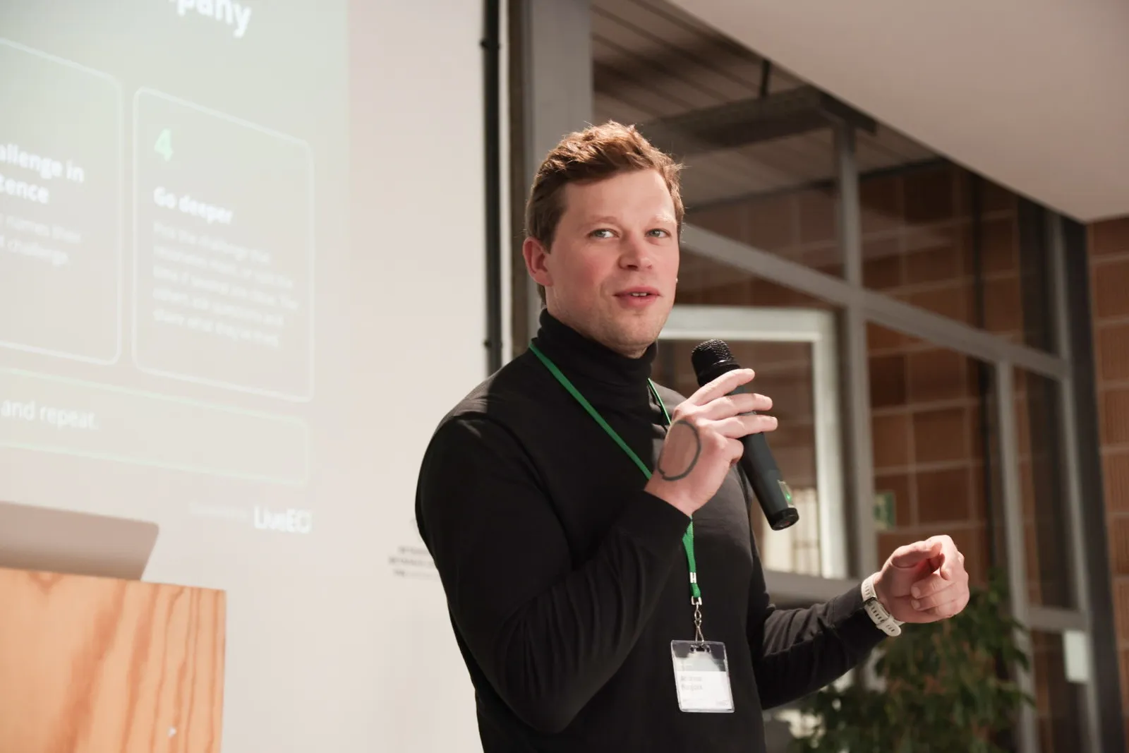 A facilitator with a microphone explaining the workshop format